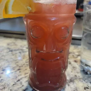 a tiki with a slice of orange