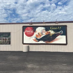 a coca cola advertisement on the side of a building