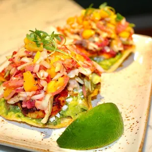 The Shrimp Tostada is made with shrimp, corn tostada, guacamole, cotija, &amp; slaw.