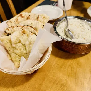 a bowl of rice and naan bread