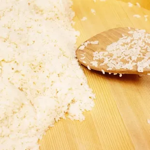 a wooden spoon and rice