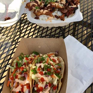 Otani tacos in the front and teriyaki chicken with rice and salad in back.