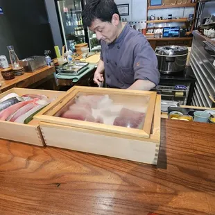 Sushi chef and his art; fresh fish from Japan