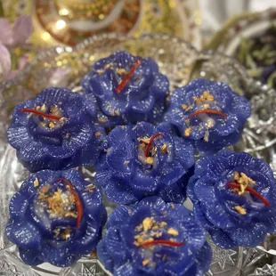 Chor Muang 
-Royal flower dumplings. Tender rice-bases dough is naturally dyed, with a sweet-savory chicken and peanut
