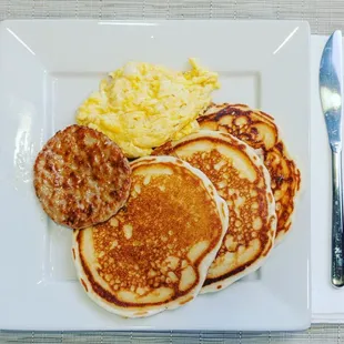 a plate of pancakes and scrambled eggs