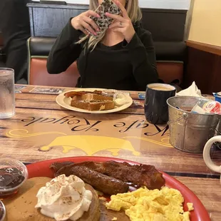 a woman taking a picture of her breakfast