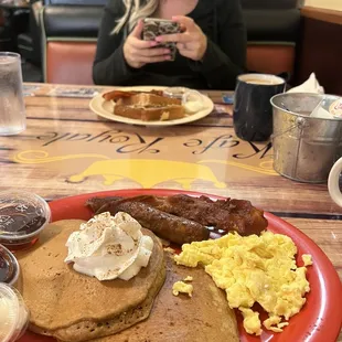 a woman taking a picture of her breakfast