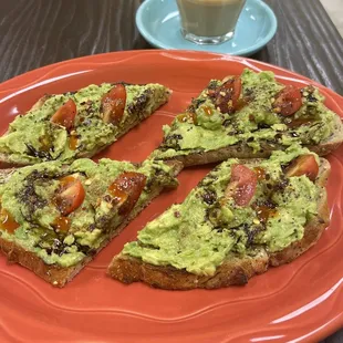 Ethiopian avocado toast! With cherry tomatoes, chili flakes, balsamic. And cortado coffee and he could not put it down!