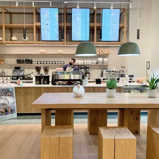 a coffee shop with wooden tables and benches