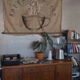 a coffee shop with a coffee cup on the wall