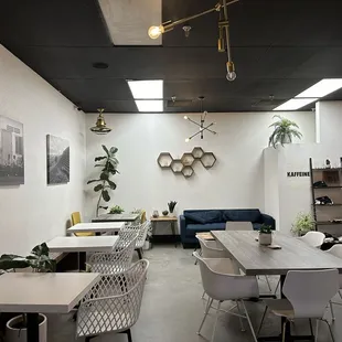 a coffee shop with a long table and chairs