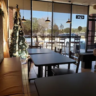 a view of a coffee shop with a christmas tree in the window