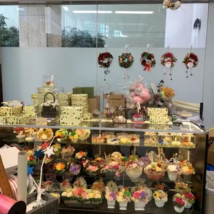 a display of cupcakes and cakes
