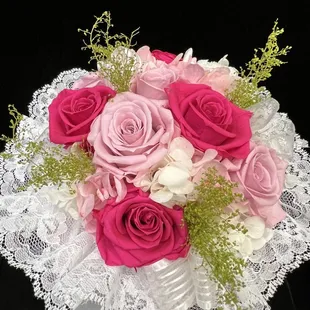 a bouquet of pink and white roses