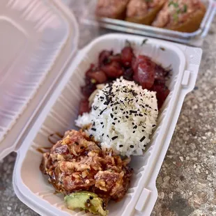 a container of rice, meat, and vegetables