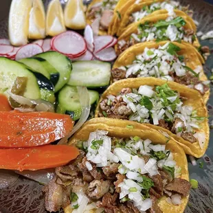 a platter of tacos and vegetables