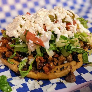 Sope Campechano. Fried tortilla, beans, lettuce, pico, jalapeno, queso fresco, sour cream, marinated steak, chorizo. $6.