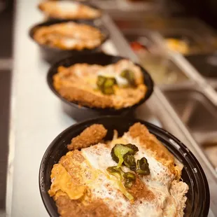 a row of bowls of food