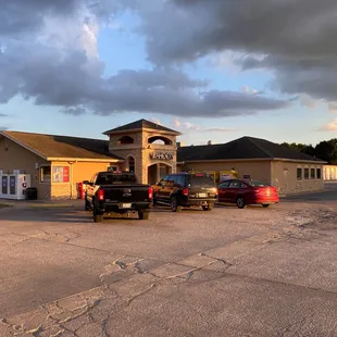 a parking lot with cars parked in front of it