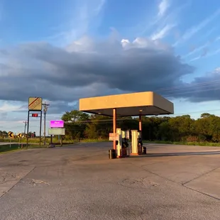a gas station with a cloudy sky