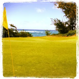 3rd hole at Kahuku Golf Course with ocean in background.
