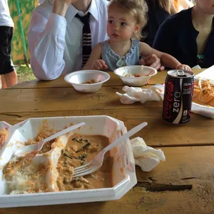 a family sitting at a picnic table