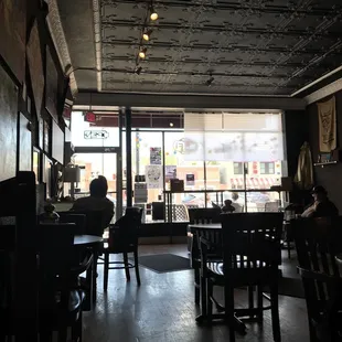 people sitting at tables in a coffee shop