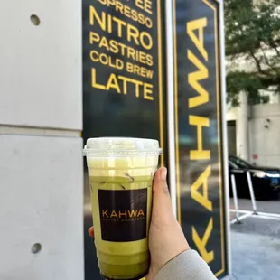 a hand holding a cup of coffee