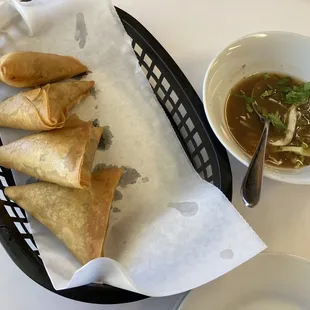 a bowl of soup and a basket of saman