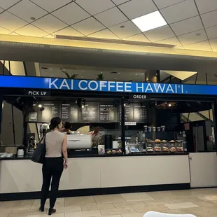 a woman standing in front of a coffee shop