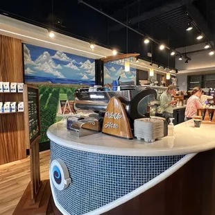 a coffee shop counter with a coffee machine