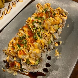 a plate of sushi and a plate of rolls