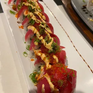 a long sushi roll on a white plate