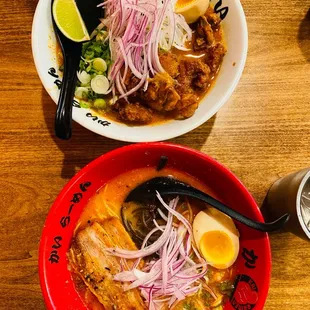 two bowls of ramen and a drink