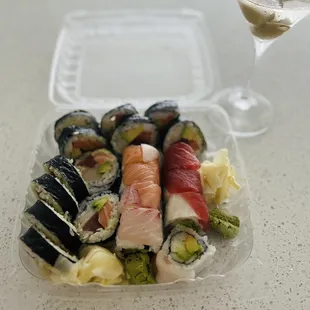 a glass of wine and a plate of sushi