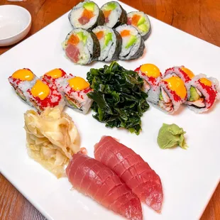 various types of sushi on a white plate