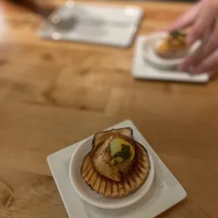 a scallop on a plate with chopsticks