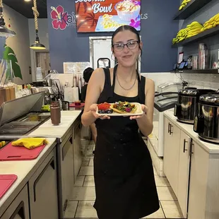 Shea offering our Avocado toast on sourdough bread topped with Microgreens.