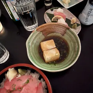 a plate of sushi and a bowl of rice