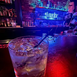 a drink in a glass on a bar