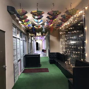 a hallway with umbrellas hanging from the ceiling