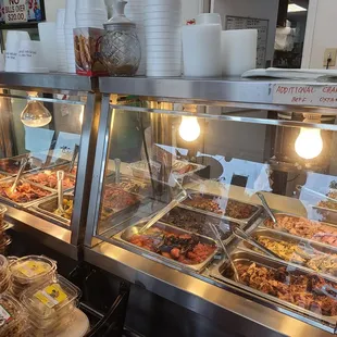 a variety of food in a display case
