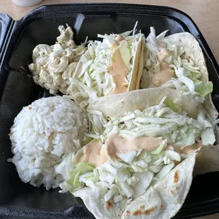 This photo contains fish tacos with mango sauce!