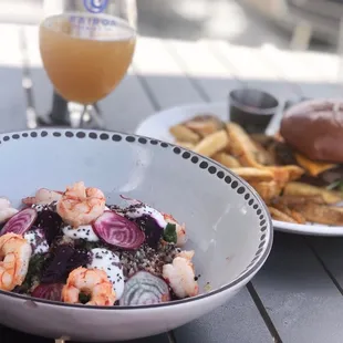 a plate of food and a glass of beer