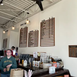 a woman standing in a coffee shop