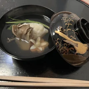 a bowl of soup and chopsticks