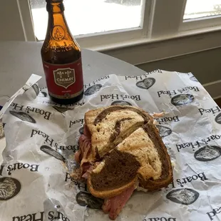 a sandwich and a bottle of beer