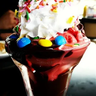 Single scoop red velvet sundae with whipped cream, sprinkles and M&amp;Ms