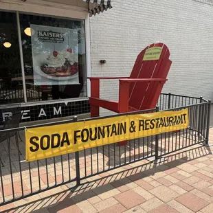a red chair in front of a soda fountain restaurant