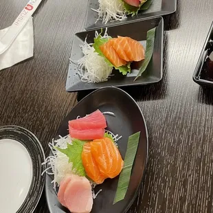 four plates of sushi on a table